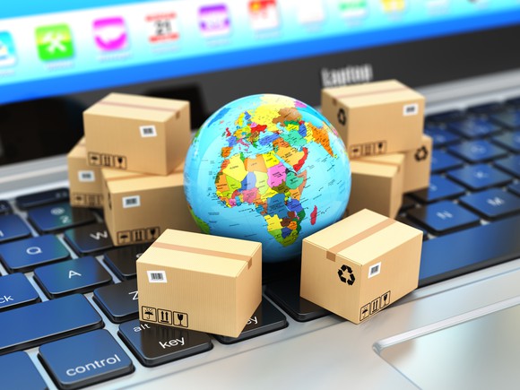 Parcels surrounding a globe on a keyboard.