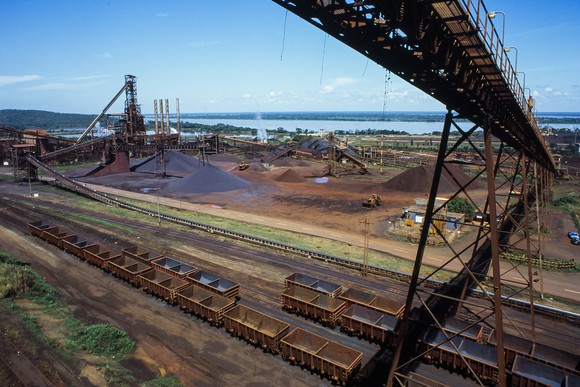 Iron ore mining facility next to a body of water in daylight
