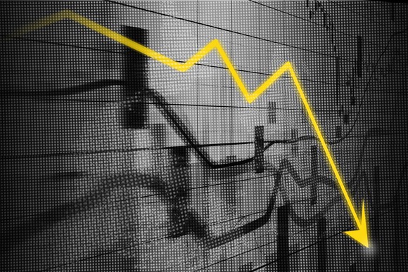 A stock chart showing downward arrow.