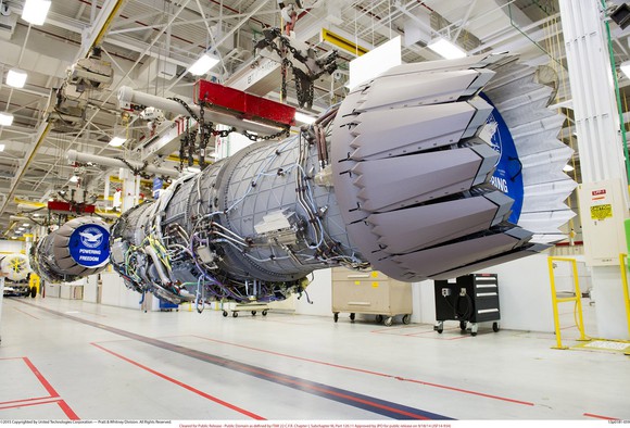 Elevated assembly line with aircraft engines in production in a large facility.