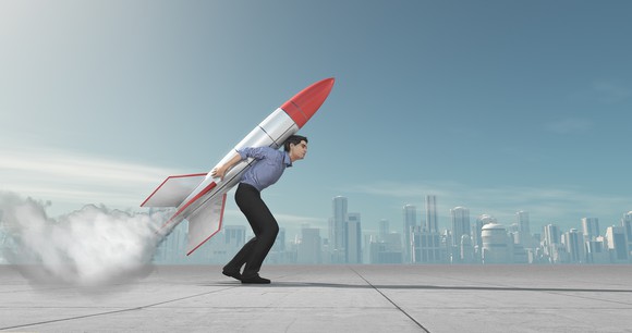Businessperson with a rocket strapped to his back.