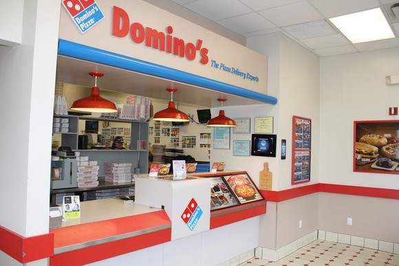 Domino's storefront lobby with signage, logo, and products.