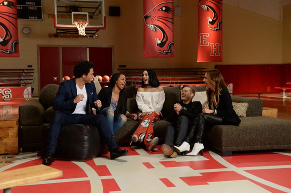 Cast members from High School Musical reunite on set.