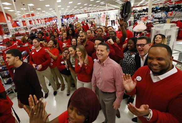 A whole lot of Target workers in red are in a store.