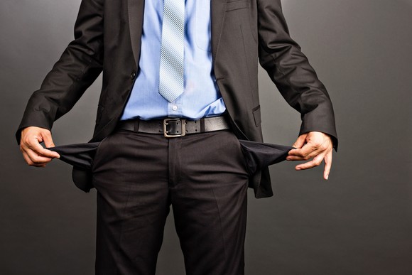 Man in suit showing his empty pant pockets