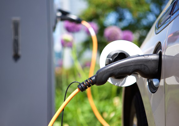 An electric vehicle plugged in outside while being charged