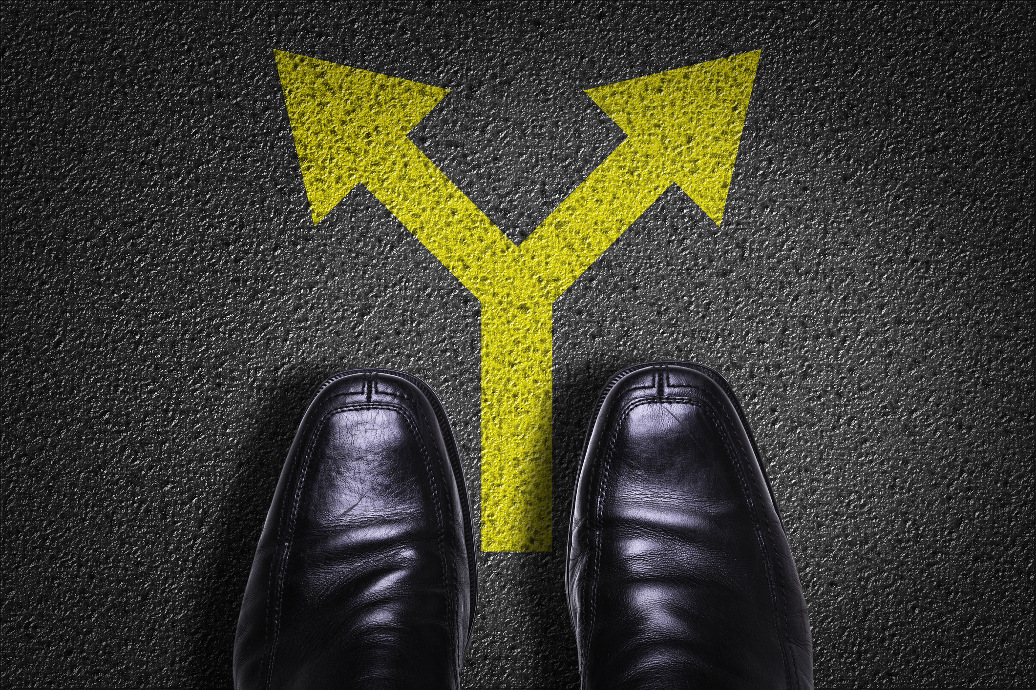 A pair of shoes with arrows indicating a fork in the road