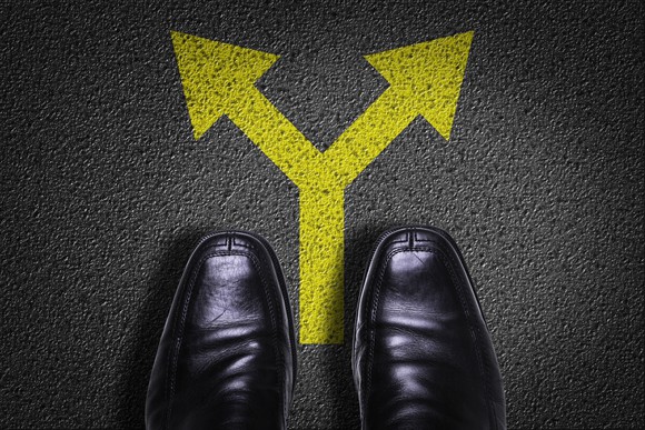 a pair of shoes with arrows indicating a fork in the road