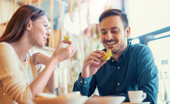 A couple eats breakfast at a coffee shop.