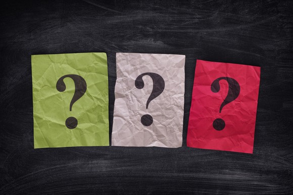 Three notes of different colors with question marks