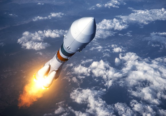 Rocket rising above clouds