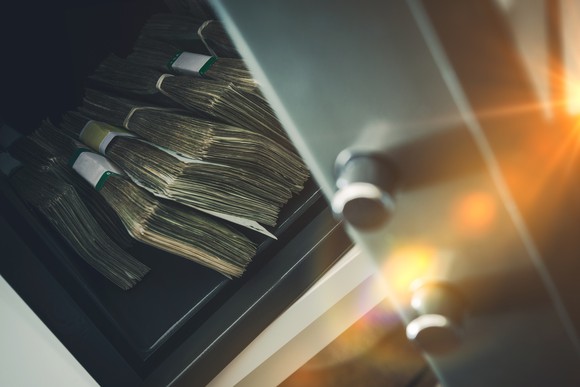 Stacks of cash sitting inside a safe.
