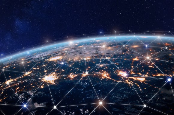 The world seen from space, with lines of light interconnecting over it