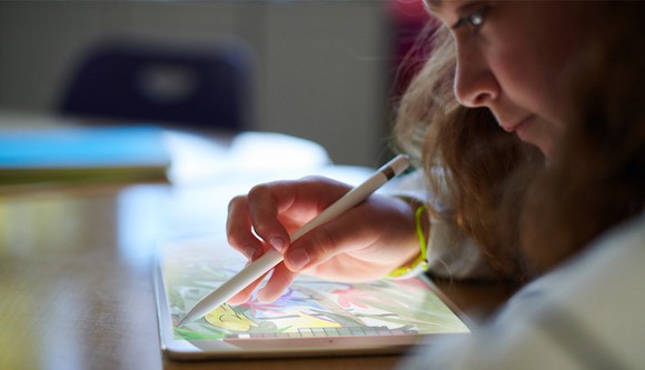 A girl using the new iPad and an Apple Pencil