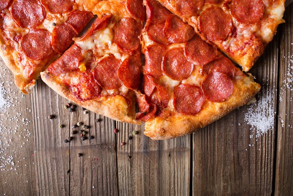 Slices of pepperoni pizza on a wooden table