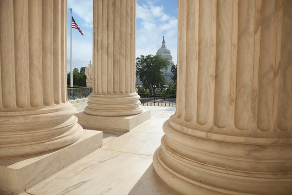 Columns and the U.S. Capitol building in the distance.