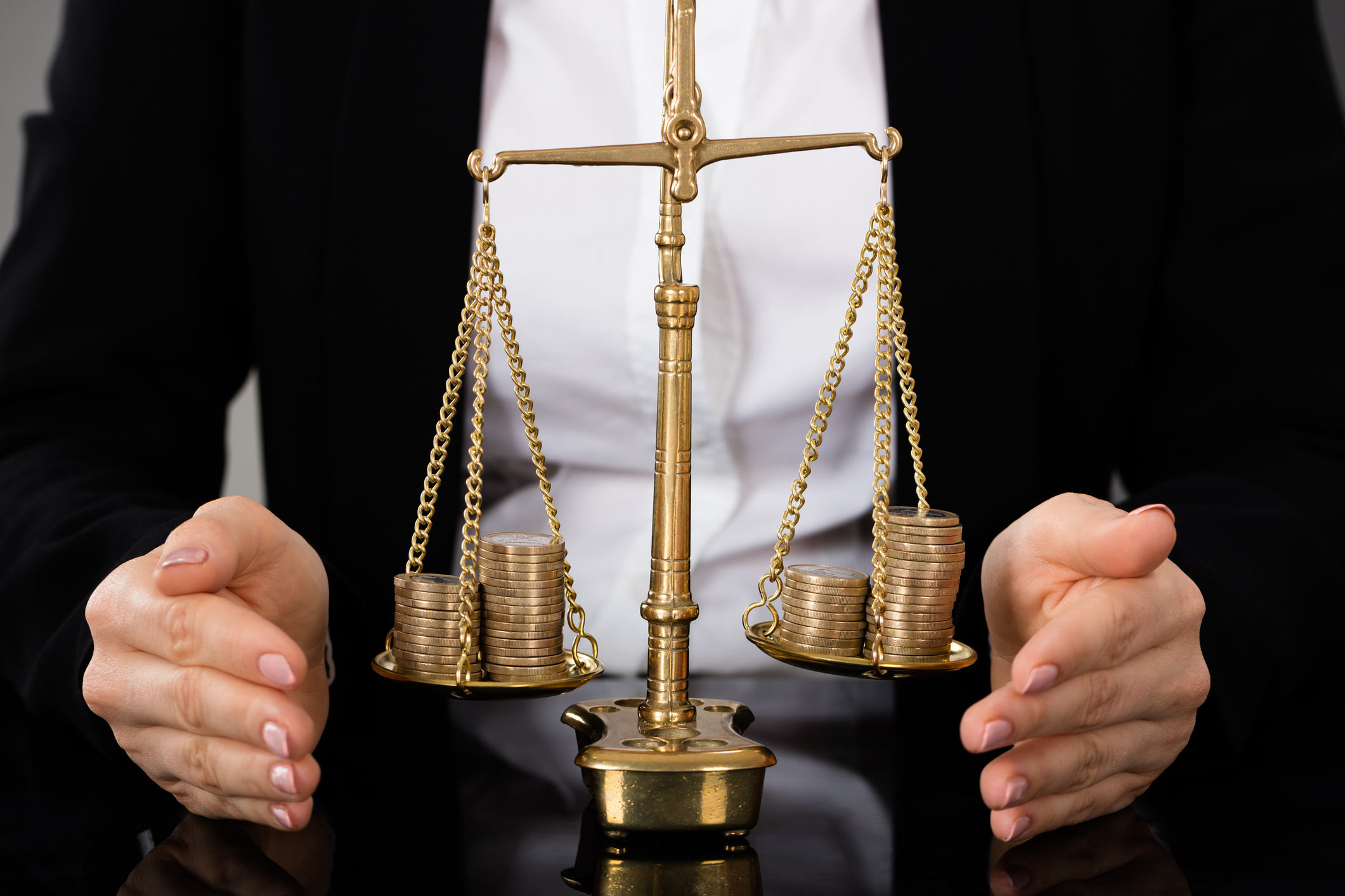 A scale roughly balanced with coins on both sides.