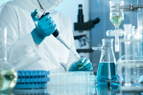 A scientist performs an experiment.
