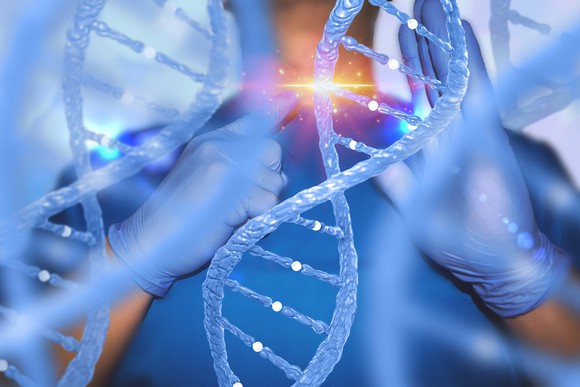 Large DNA helix with scientist in background "cutting" the DNA