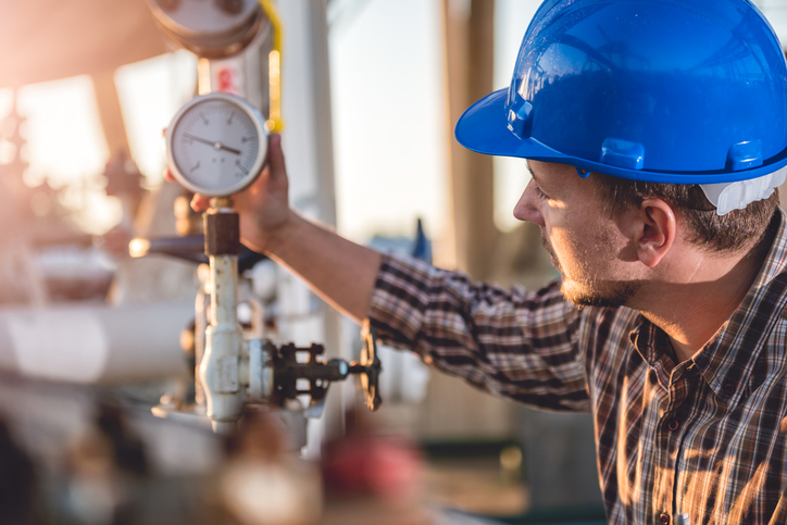 A man checking a manometer.