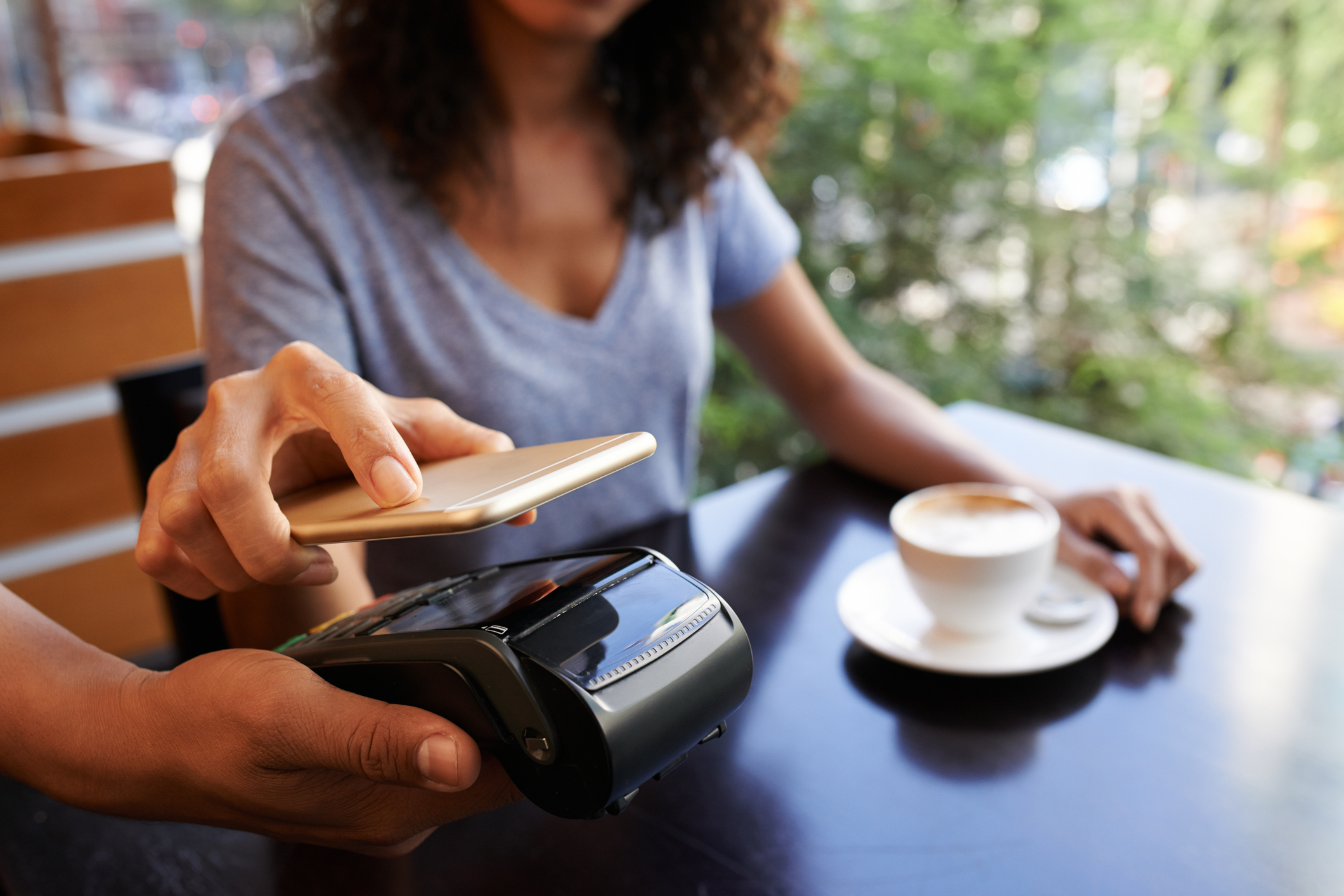 Woman paying for coffee with her phone