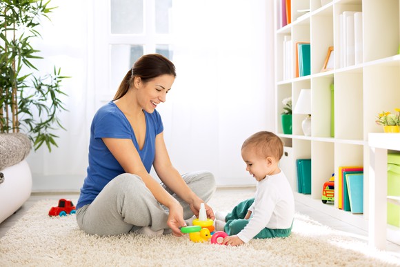 Woman and baby playing on the floor