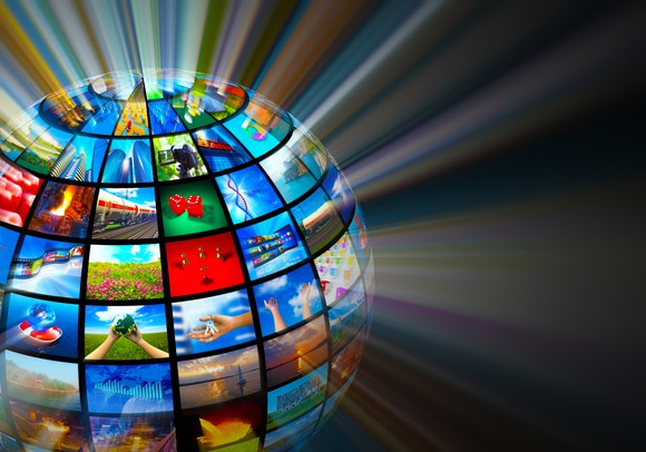 A globe made up of screens, with each screen showing a different picture.