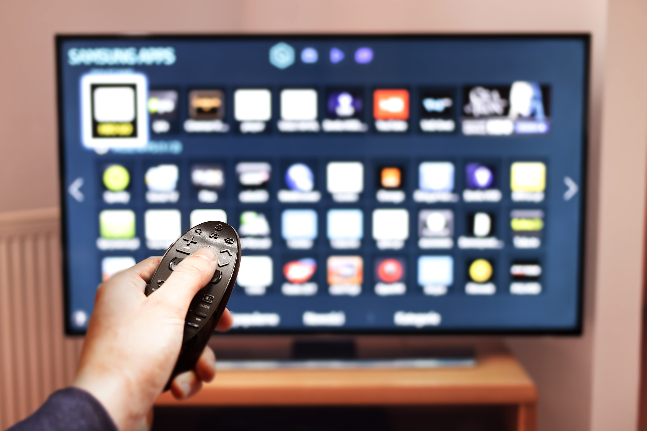 A man browses programs on a smart TV.