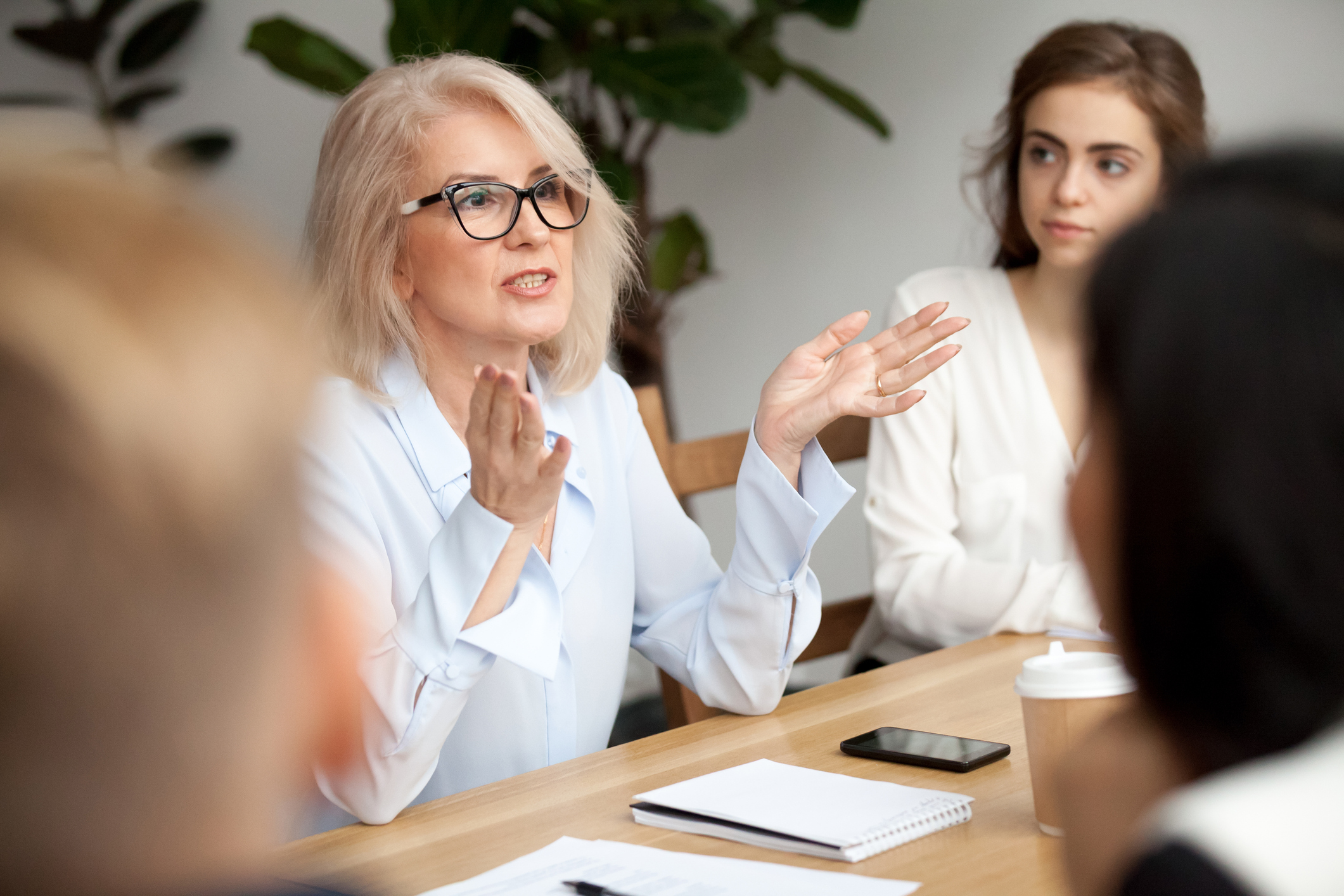A woman talks to younger people.