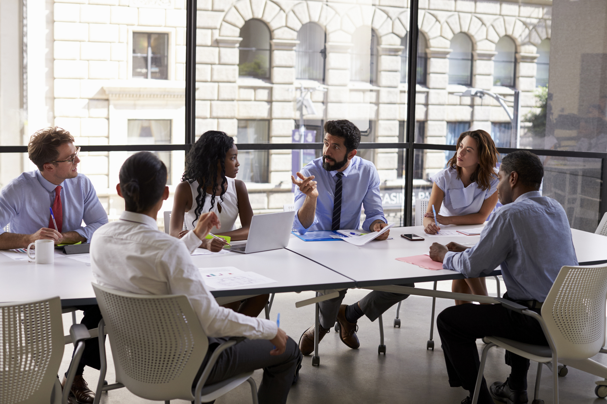 Professionals gathered around a table in an office.
