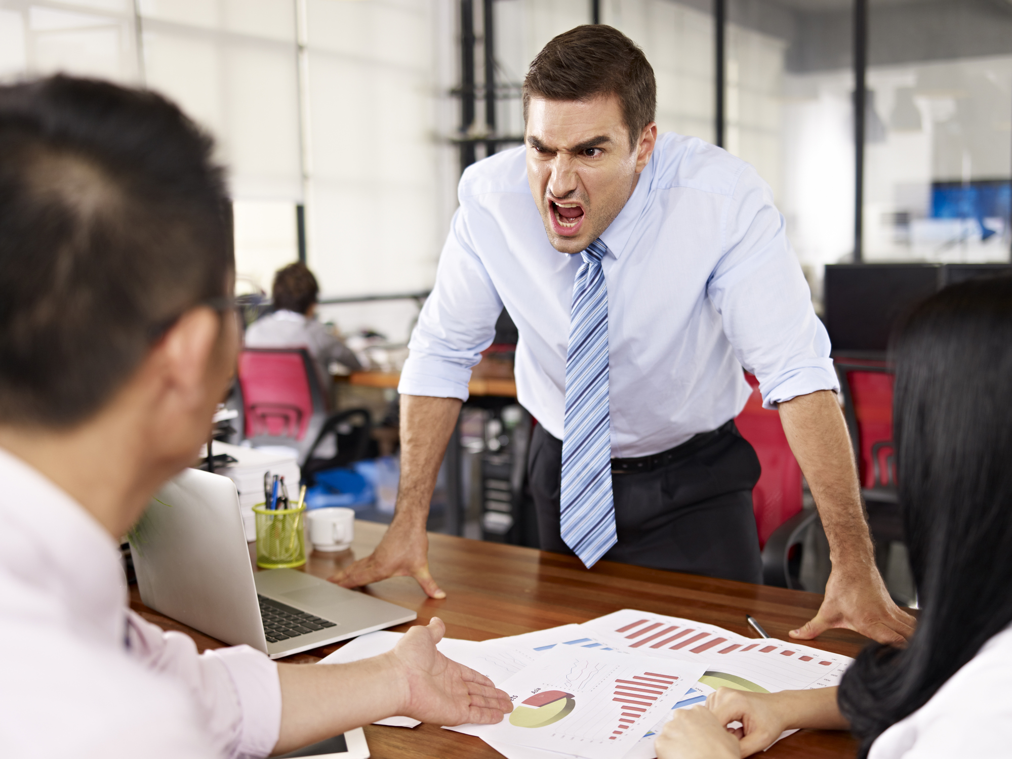 An angry man is yelling at a group.