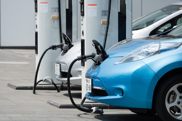 Electric vehicle plugged in at a charging station.