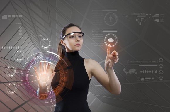 A woman manipulates a mixed reality display.