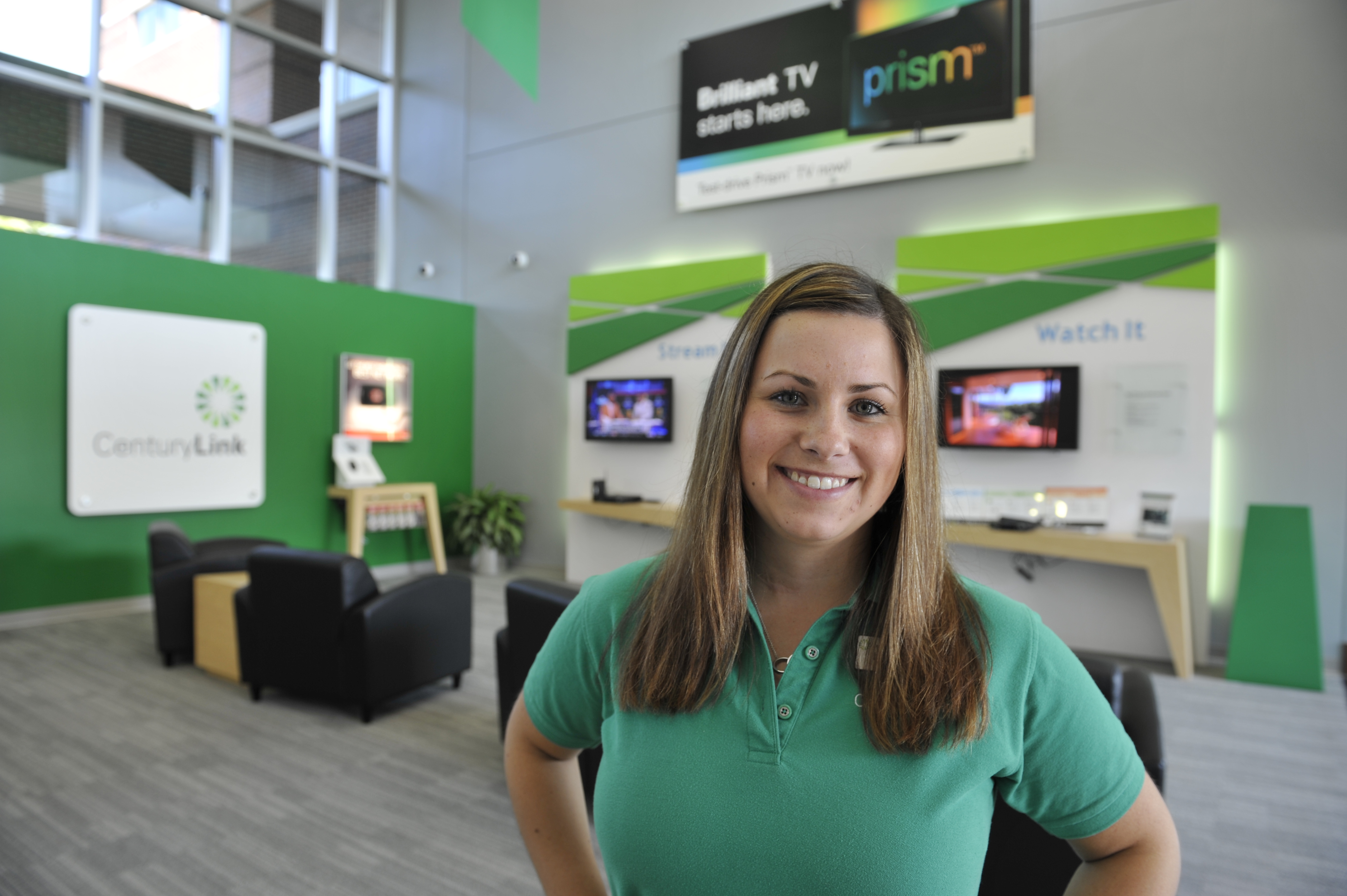A CenturyLink rep smiling at a demonstration office.