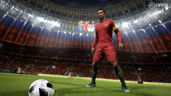 Screenshot of FIFA video game depicting a soccer player standing on the field of a stadium behind a soccer ball.