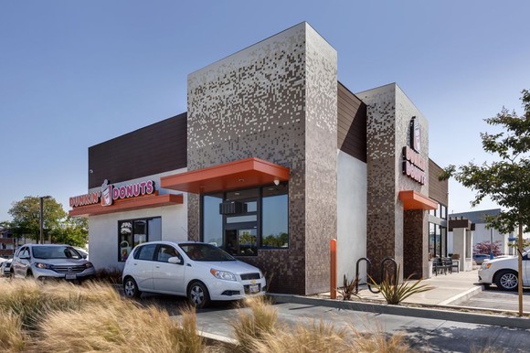 A Dunkin' Donuts store with a drive-thru lane