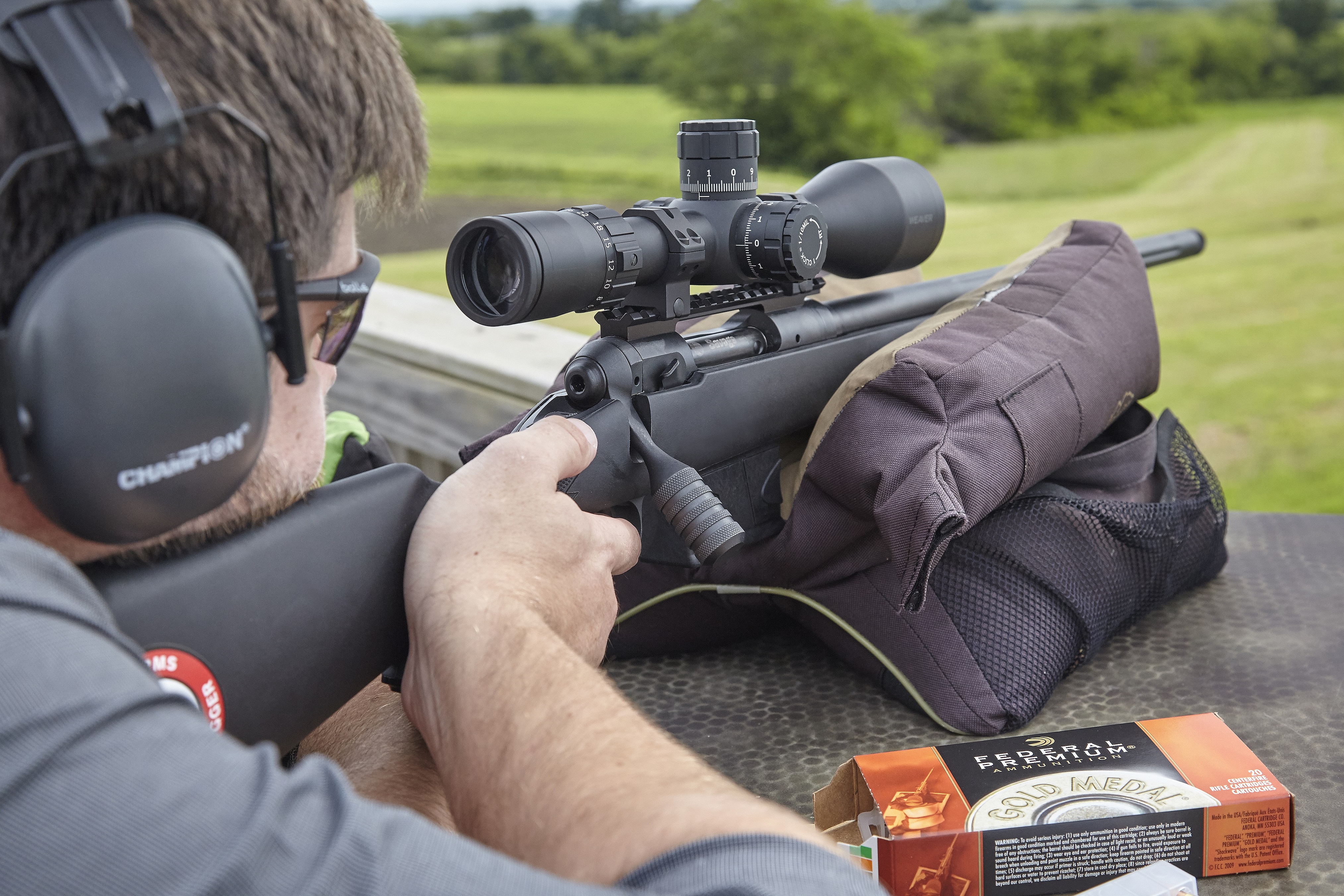 Man shooting a scoped rifle