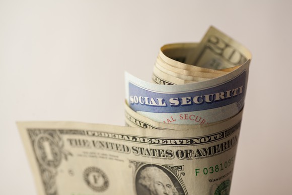Social Security card wrapped in bundle of money.
