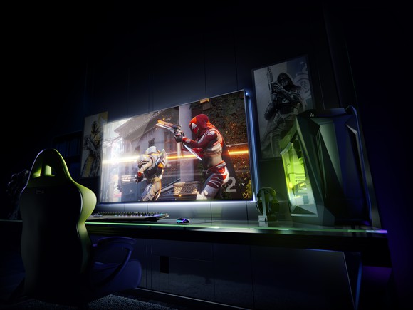 A big screen and a gaming computer on a desk.