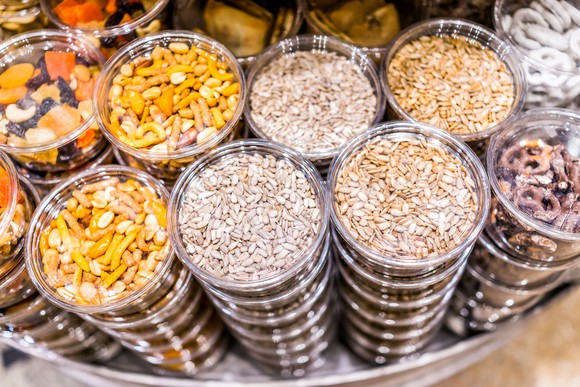 Containers of nuts and other snacks are stacked high.