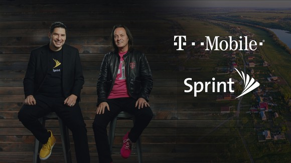 Sprint CEO Marcelo Claure and T-Mobile CEO John Legere sitting on stools next to each other.