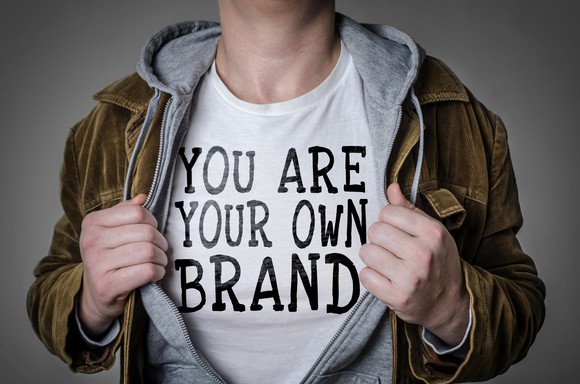 A man wears a shirt that says you are your own personal brand.
