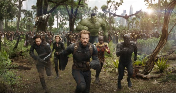 The Avengers, led by Captain America and Black Panther, run towards an unseen foe