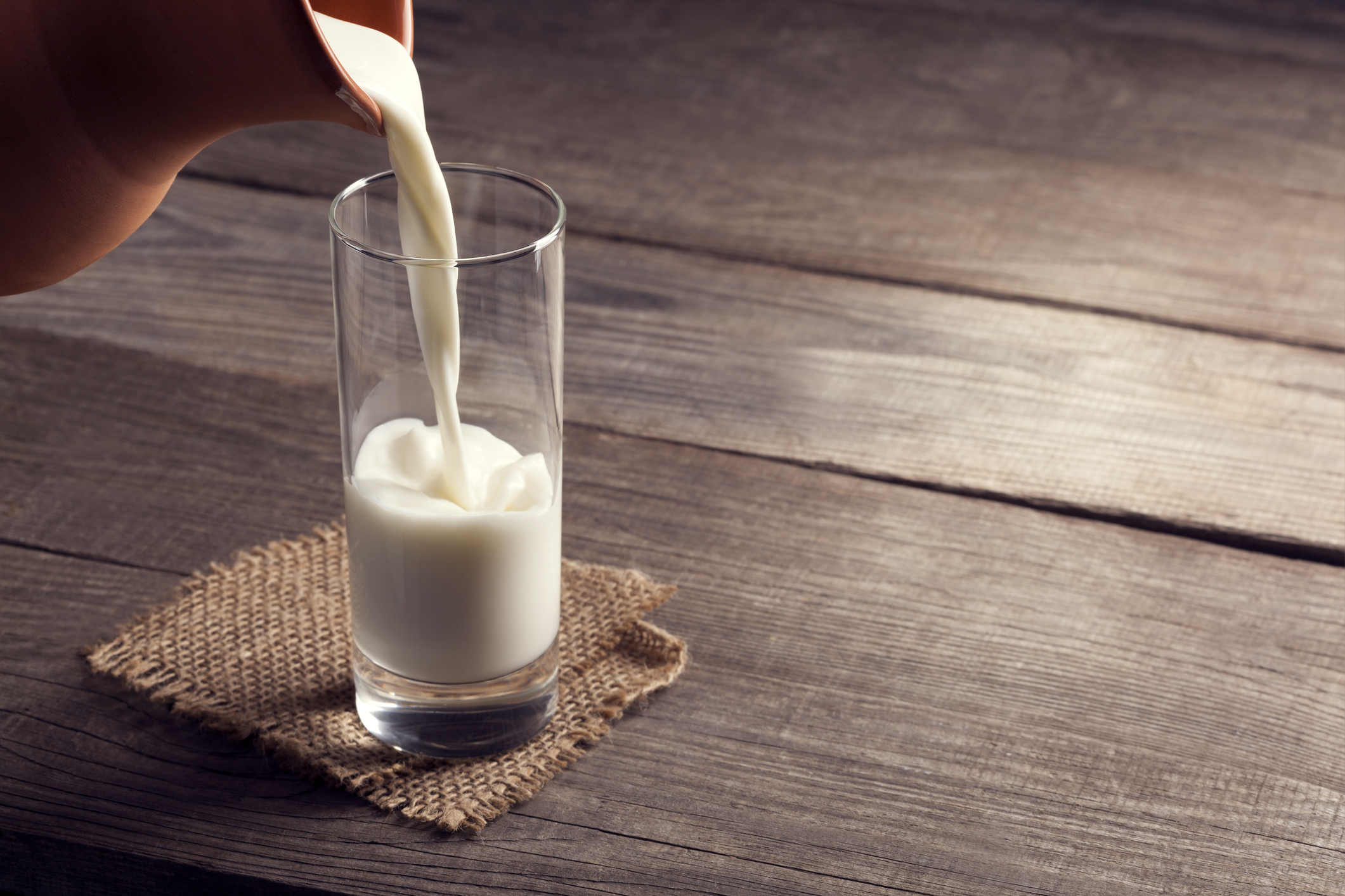 Milk being poured into a glass.