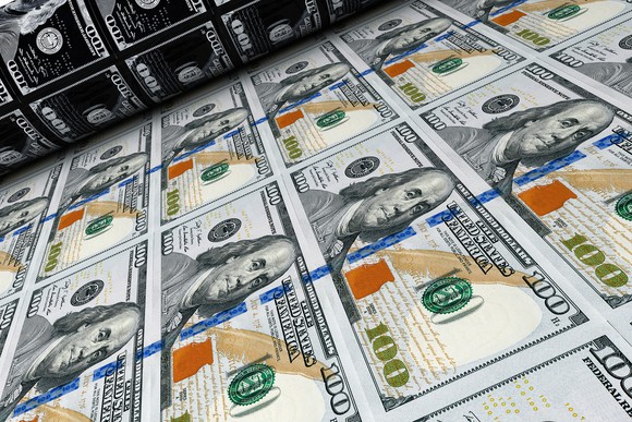 A printing press making hundred dollar bills.