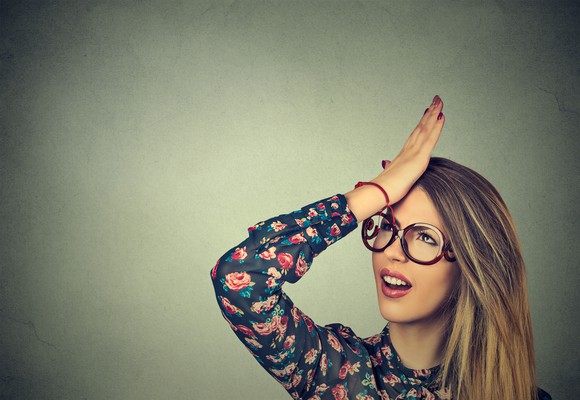 Woman smacking her own head.