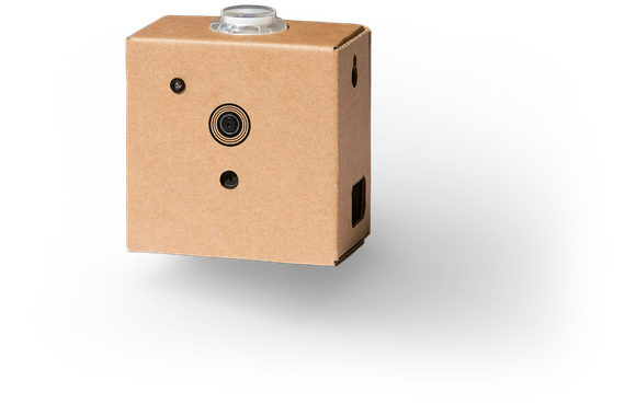 A small cardboard rectangle with a lens on the front that houses the vision kit.