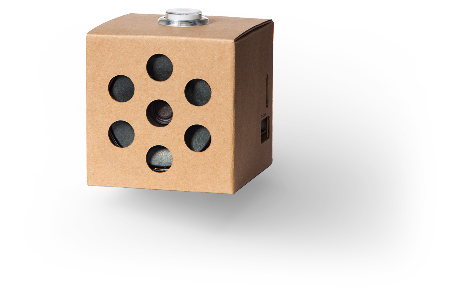 A small cardboard box with holes on the front that houses the Google Voice AIY kit.