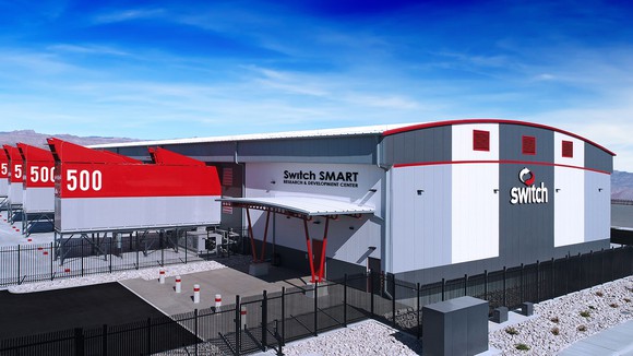 Building with Switch logo on it, and data-center modules attached to open bays in the building.
