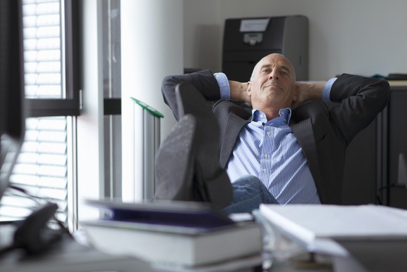 Professional man with feet up on desk